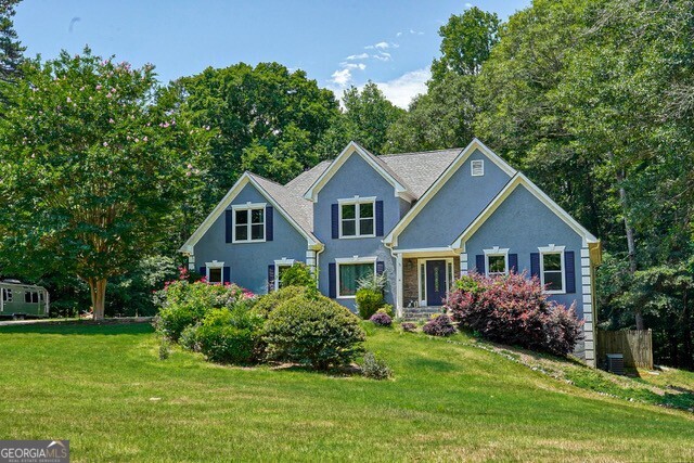 335 Butterfield Lane Fayetteville, GA 30214 - Photo 1 of 27 a front view of a house with a yard and trees