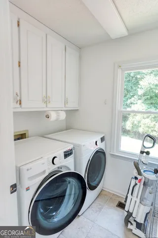 a utility room with sink washing machine and dryer