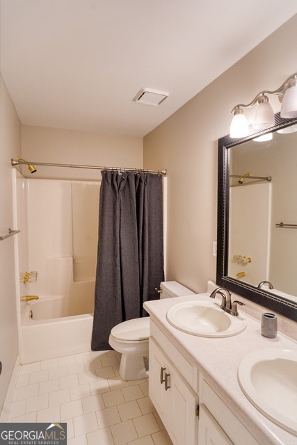 335 Butterfield Lane Fayetteville, GA 30214 - Photo 20 of 27 a bathroom with a sink a toilet a mirror and shower