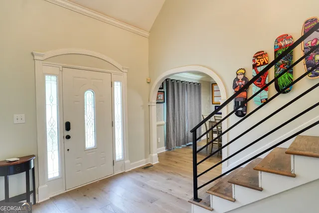 a view of an entryway with wooden floor