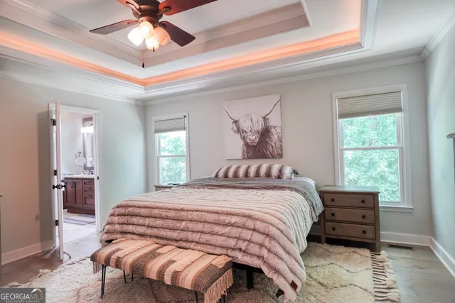 a bedroom with a bed and a chandelier