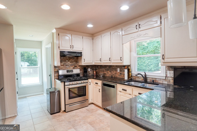 335 Butterfield Lane Fayetteville, GA 30214 - Photo 6 of 27 a kitchen with granite countertop a sink stainless steel appliances and cabinets