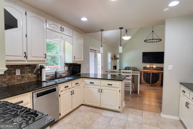 a kitchen with a sink cabinets and window