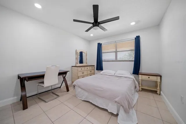 a bedroom with a bed a desk and chair