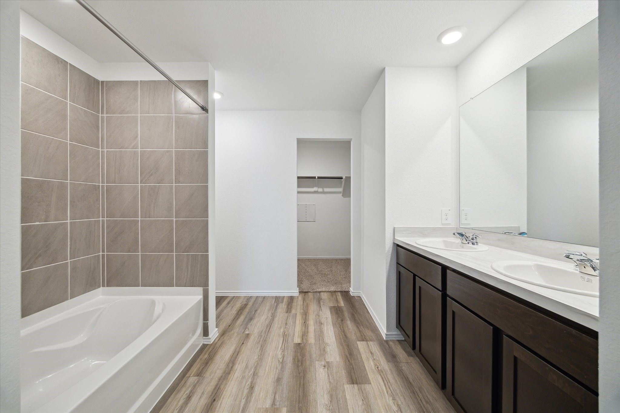 1002 Concord Pointe Lane Houston, TX 77090 - Photo 8 of 10 a bathroom with a tub sink and mirror