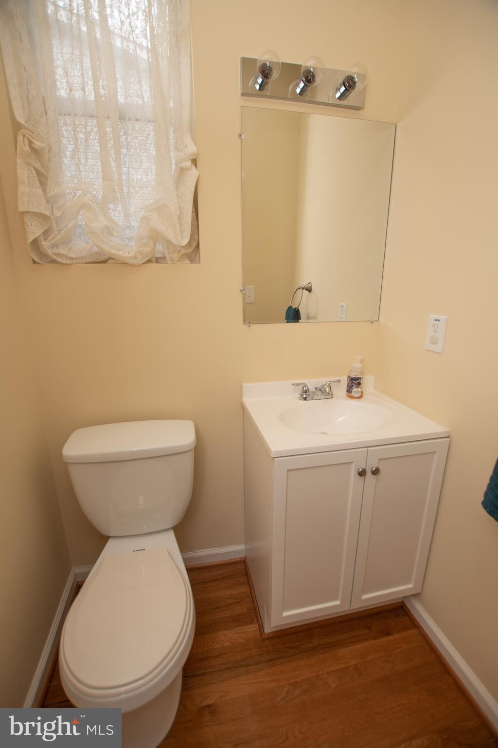 67 Edmondson Ridge Road Baltimore, MD 21228 - Photo 24 of 41 a bathroom with a sink mirror and toilet