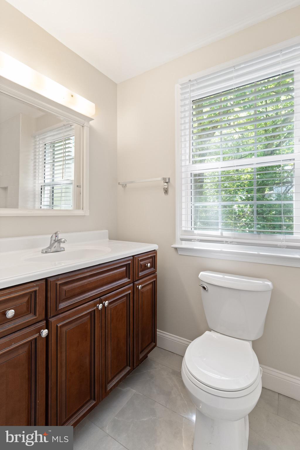 8581 Chester Grove Court Springfield, VA 22153 - Photo 25 of 38 a bathroom with a toilet sink and mirror