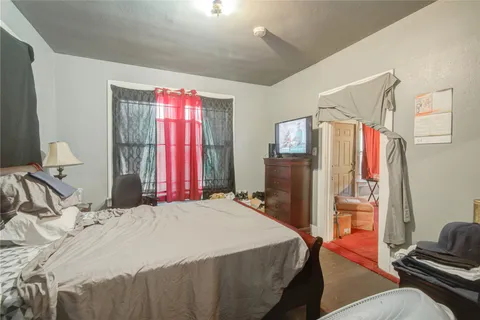 a bedroom with a bed dresser and a window