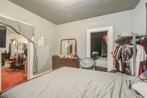a bedroom with bed and a closet