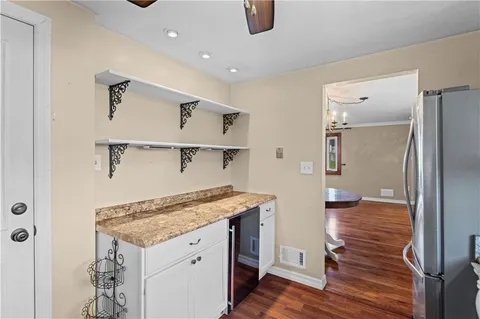 a view of a kitchen cabinets a sink and wooden floor