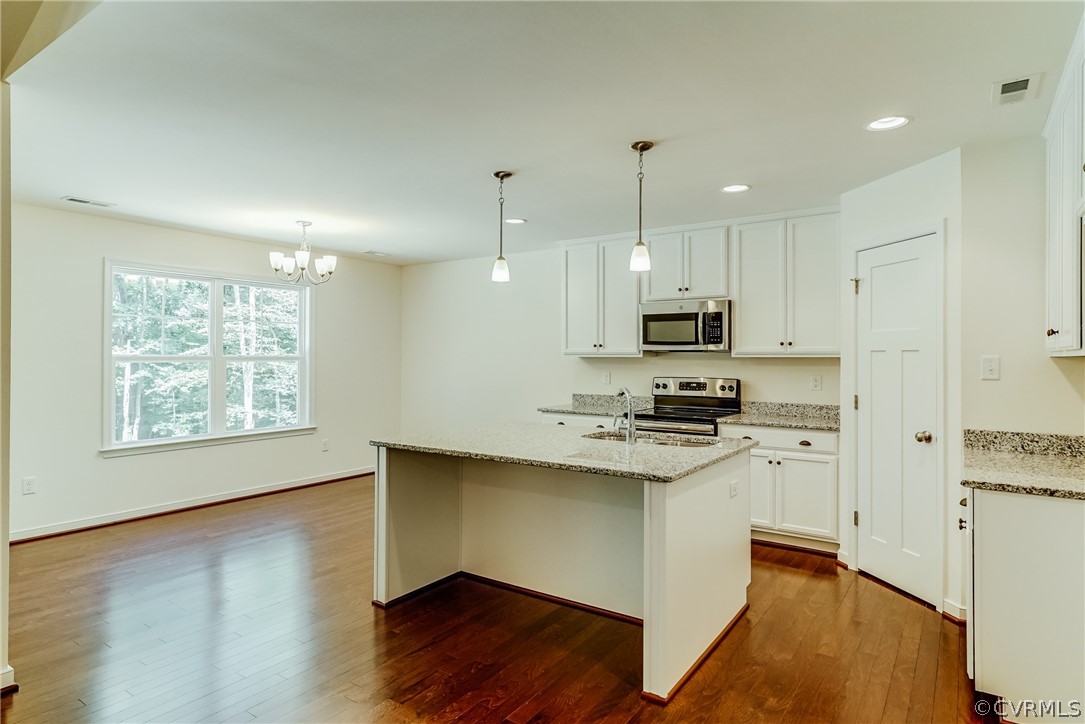 7301 Appelman Road Chesterfield, VA 23832 - Photo 2 of 14 a kitchen with stainless steel appliances granite countertop a stove a sink dishwasher and a refrigerator with wooden floor