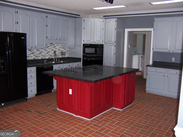 a kitchen with stainless steel appliances a stove a sink and a refrigerator