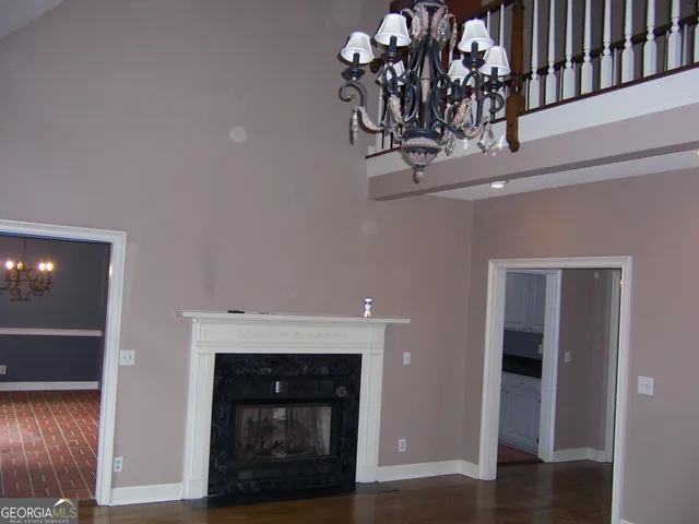 a living room with a fireplace and a wooden floor
