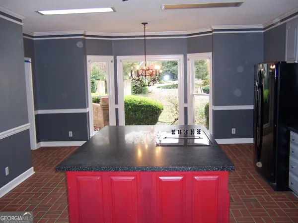 a kitchen with a sink refrigerator and window