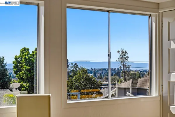 a bedroom with a bed and a refrigerator