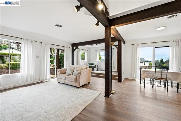 a kitchen with wooden floors and stainless steel appliances
