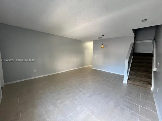a view of an empty room with stairs
