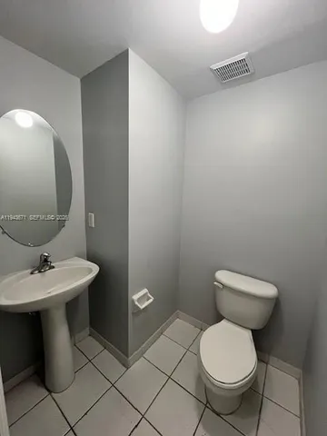 a white toilet sitting next to a bathroom sink