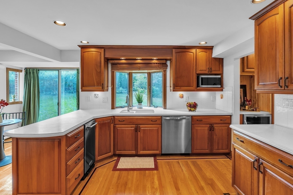 493 Salisbury Street Worcester, MA 01609 - Photo 15 of 42 a large kitchen with stainless steel appliances wooden floors and wooden cabinets