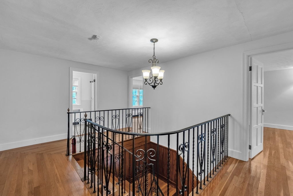 493 Salisbury Street Worcester, MA 01609 - Photo 23 of 42 a view of a hallway with wooden floor and staircase