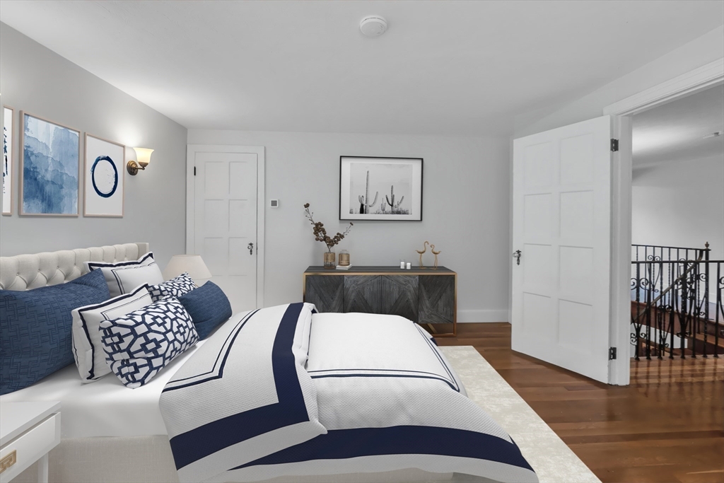 493 Salisbury Street Worcester, MA 01609 - Photo 28 of 42 a bedroom with a bed and wooden floor