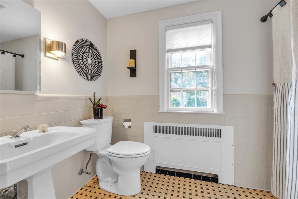 493 Salisbury Street Worcester, MA 01609 - Photo 30 of 42 a bathroom with a toilet a sink and a mirror
