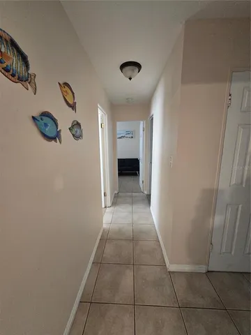 a view of a hallway to rooms and stairs