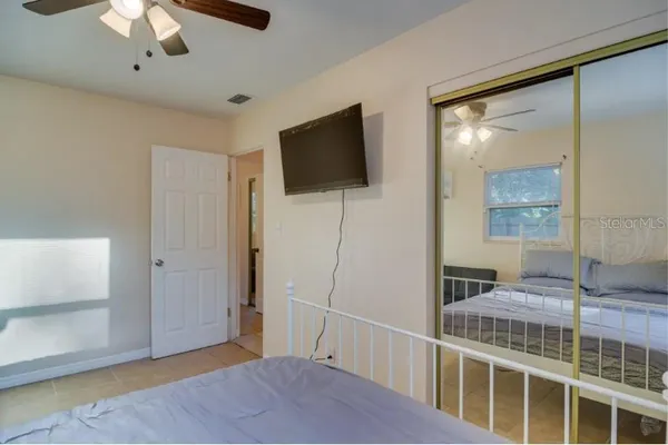 a bedroom with a bed and a flat screen tv