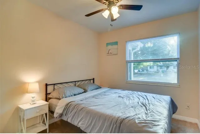 a bedroom with a bed and a window