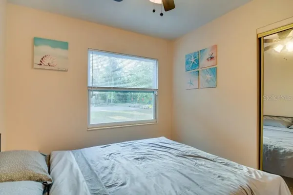 a bedroom with a bed and a window