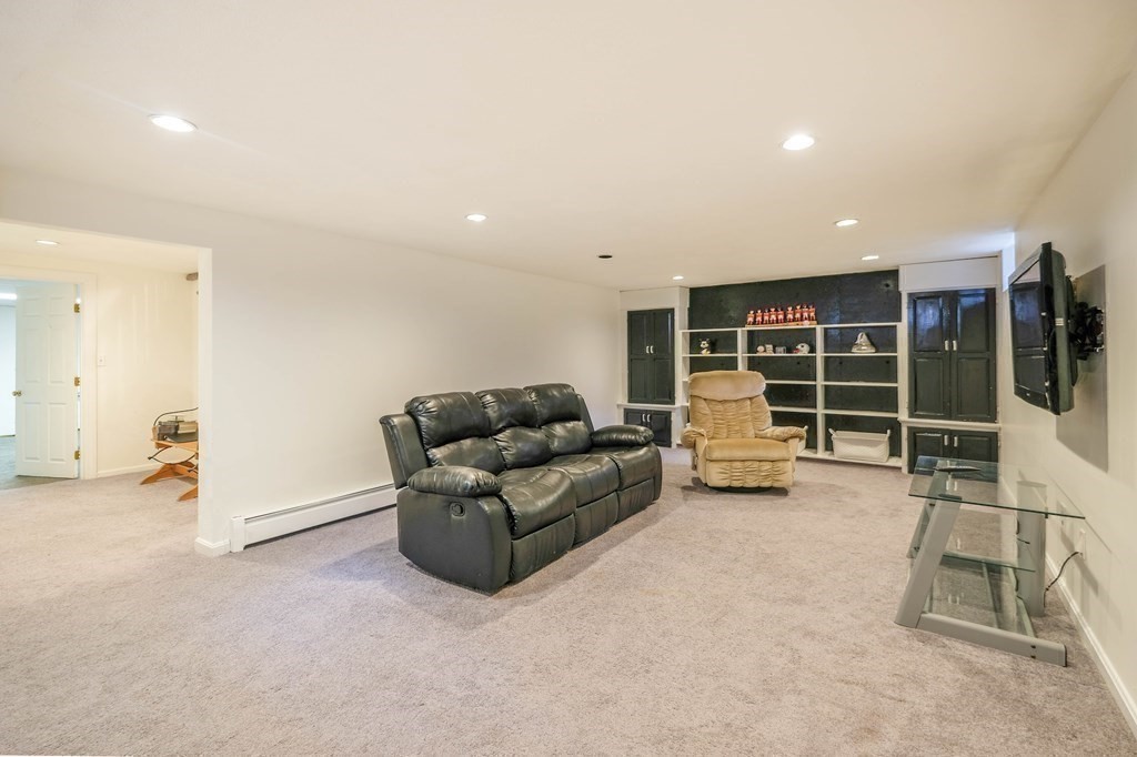 73 Draper Road Wayland, MA 01778 - Photo 12 of 13 a living room with furniture and a large window