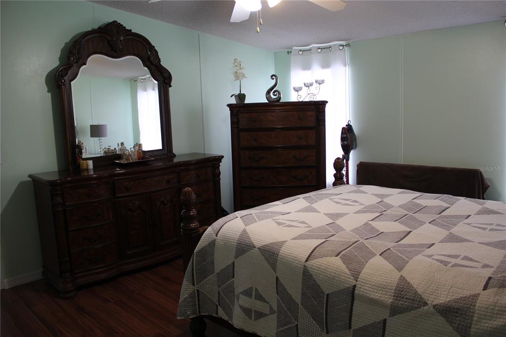 13127 Star Road Brooksville, FL 34613 - Photo 19 of 54 a bedroom with a bed and a dresser