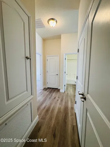 a view of water heater room with wooden floor