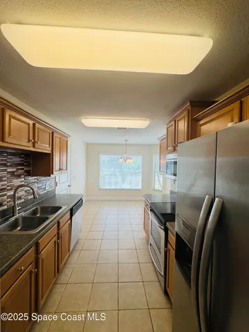 a kitchen with stainless steel appliances a refrigerator and a stove