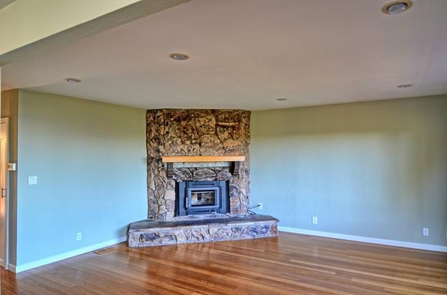 252 Swett Road Woodside, CA 94062 - Photo 5 of 21 a view of an empty room with wooden floor and a fireplace
