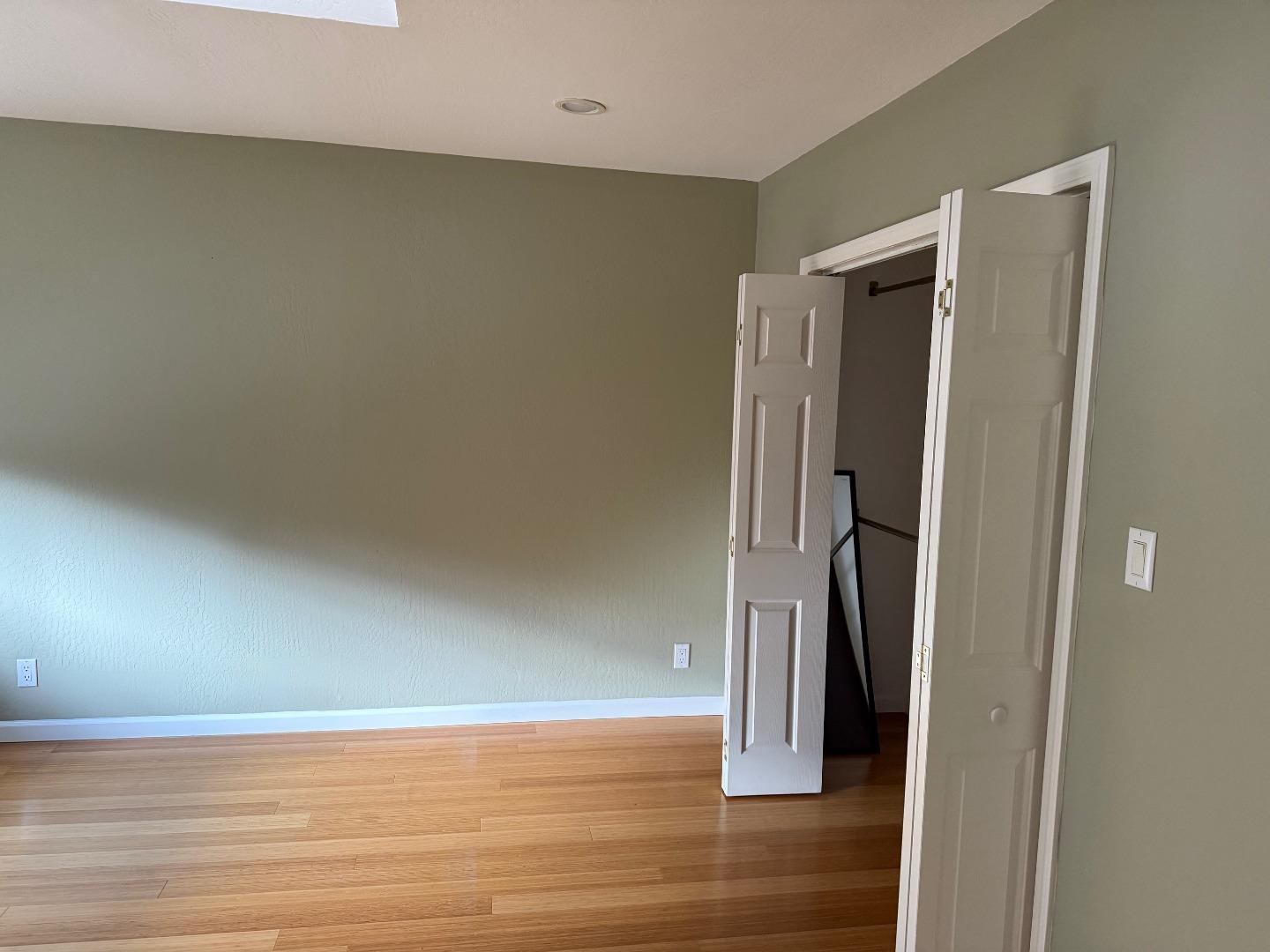 252 Swett Road Woodside, CA 94062 - Photo 6 of 21 a view of an empty room with wooden floor and a window
