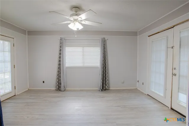 a view of an empty room with a window