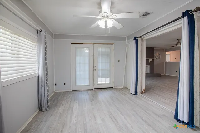 wooden floor in an empty room with a window