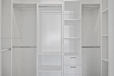 a bathroom with a shower sink vanity and toilet