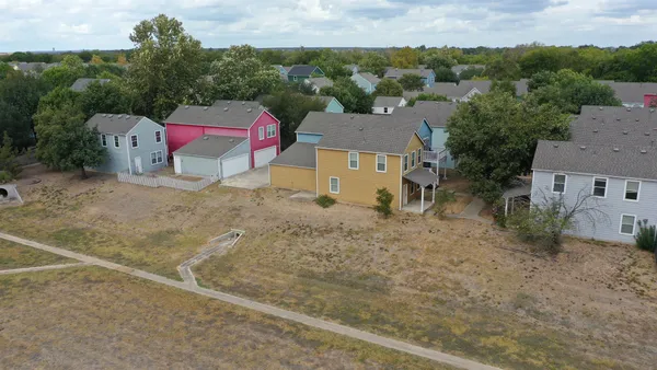 an aerial view of a house with a yard