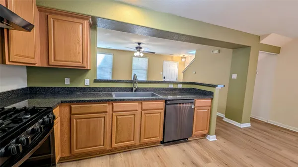 a view of walk in closet with window and chandelier