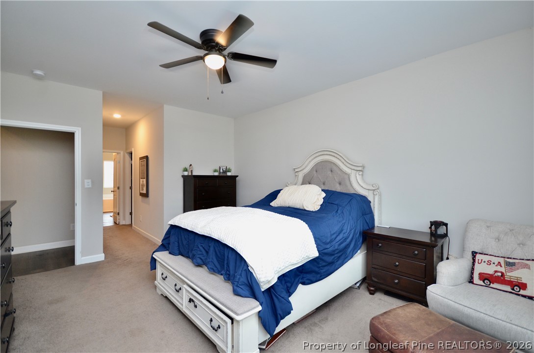 1865 John B Carter Road Fayetteville, NC 28312 - Photo 17 of 49 a bedroom with a bed and a chandelier