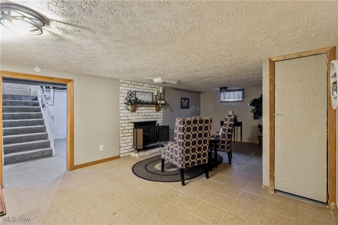 6623 Center Road Ashtabula, OH 44004 - Photo 34 of 49 Sitting room featuring baseboards, a textured ceiling, stairs, and light tile patterned floors