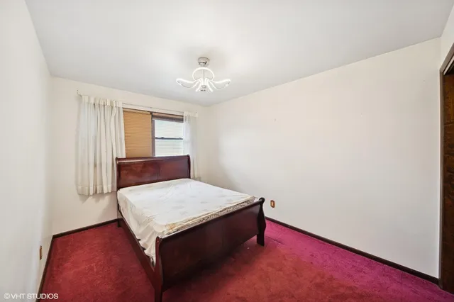 a room with a bed and a chandelier