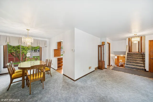 a dining room with furniture and a kitchen view