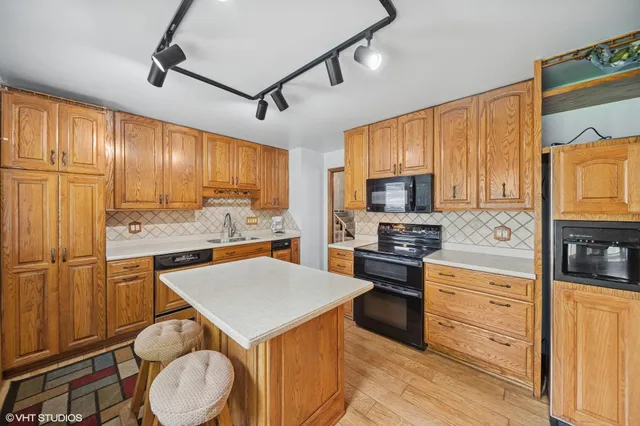 a kitchen with granite countertop stainless steel appliances and wooden cabinets