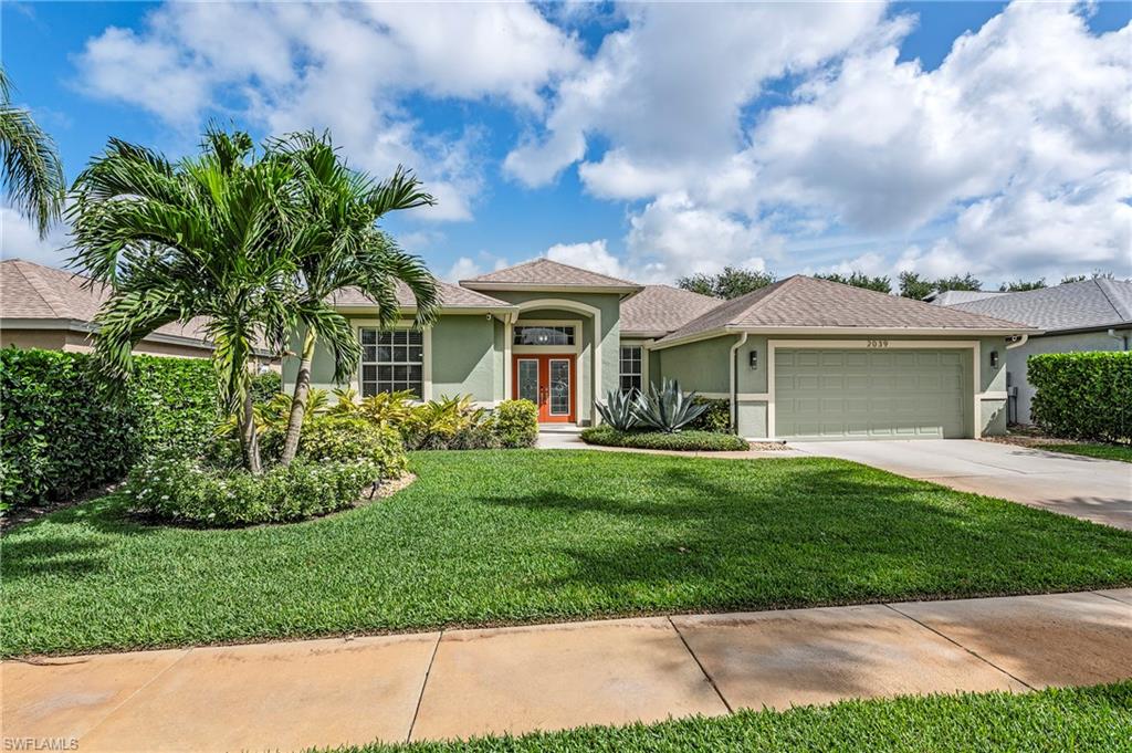 2039 Terrazzo Lane Naples, FL 34104 - Photo 1 of 29 a front view of a house with a yard