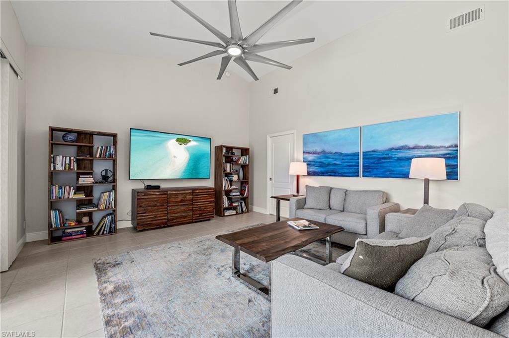 2039 Terrazzo Lane Naples, FL 34104 - Photo 11 of 29 a living room with furniture and a flat screen tv