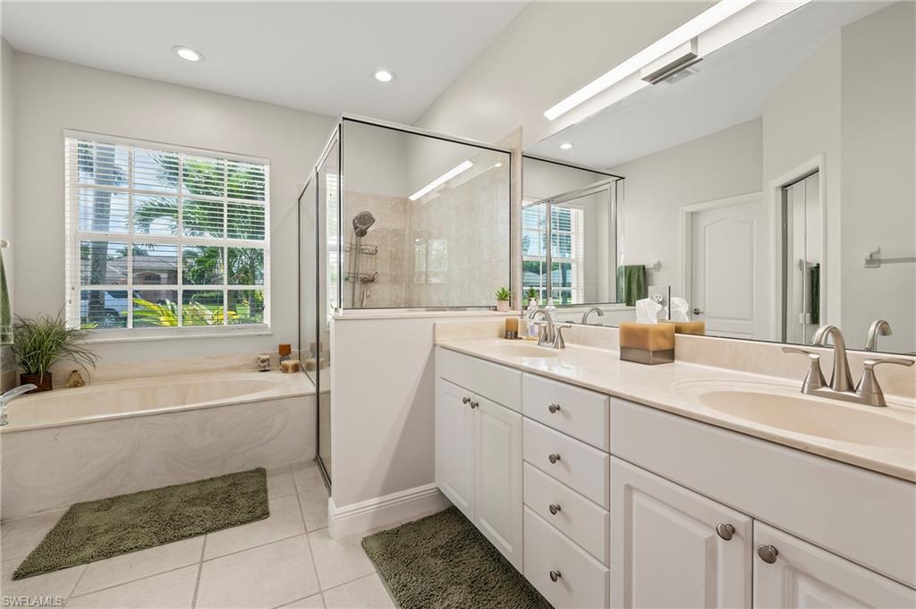 2039 Terrazzo Lane Naples, FL 34104 - Photo 14 of 29 a bathroom with a tub sink shower and mirror