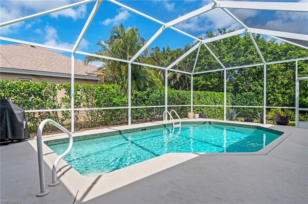 2039 Terrazzo Lane Naples, FL 34104 - Photo 20 of 29 a view of a backyard with a swimming pool
